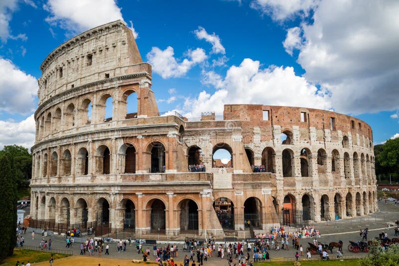 Colosseum with clear blue sky and clouds, Rome. Rome architecture and landmark. Rome Colosseum is one of the best known monuments of Rome and Italy. Colosseum with clear blue sky and clouds, Rome. Rome architecture and landmark. Rome Colosseum is one of the best known monuments of Rome and Italy