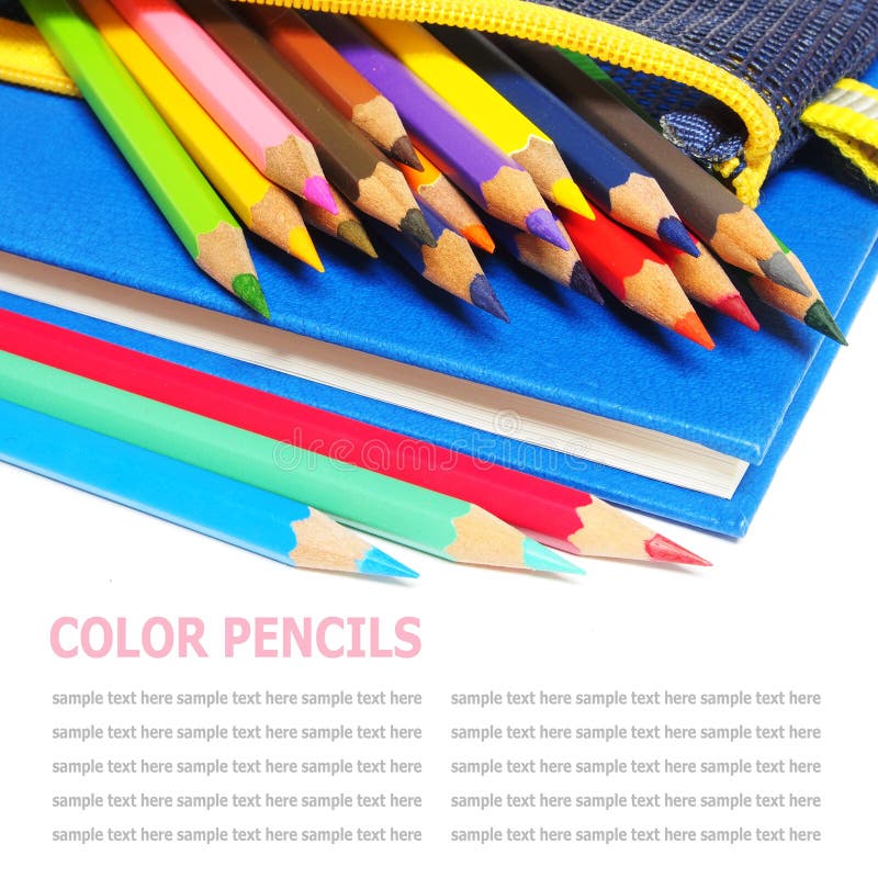 Colour pencils and a blue note book isolated on white