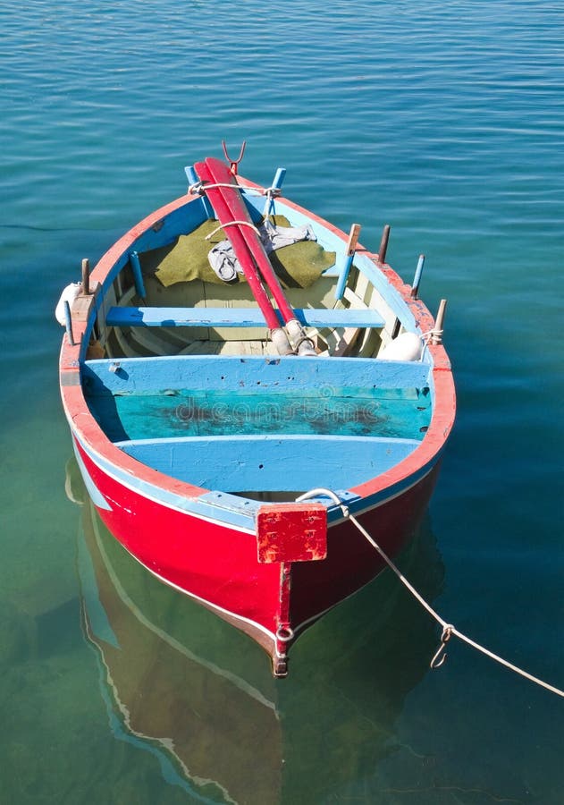 Coloured rowboat in clear sea.