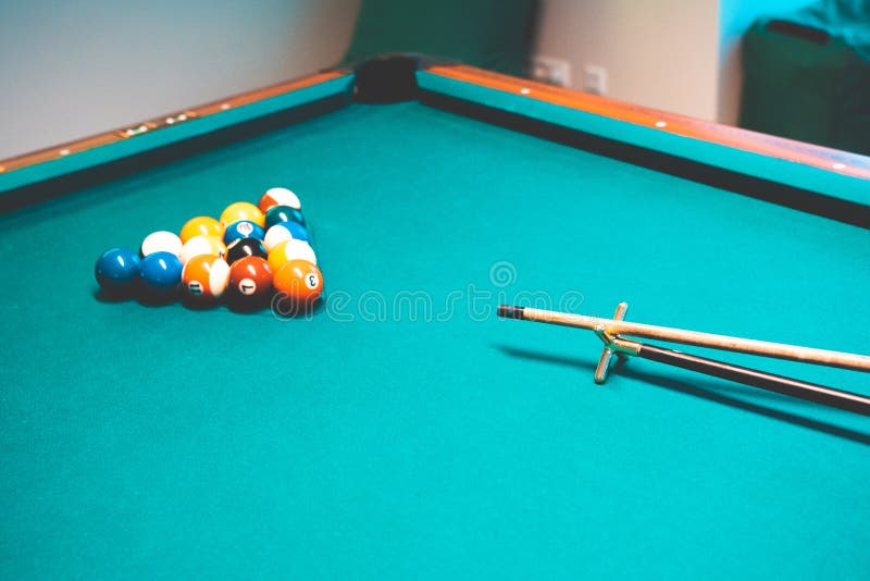 Colourful Billiard Balls and the Cue Stick on the Billiard Table Stock