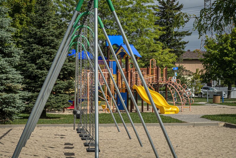 Childreens Outside Playground With Swings And Slides Stock Photo