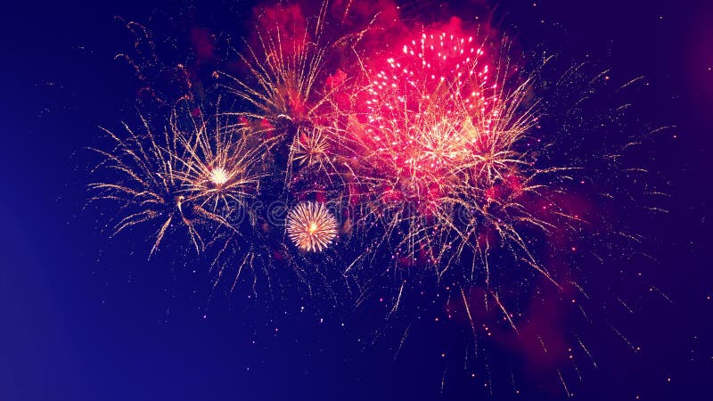 Colourful flashes of fireworks are bursting in the sky stock footage