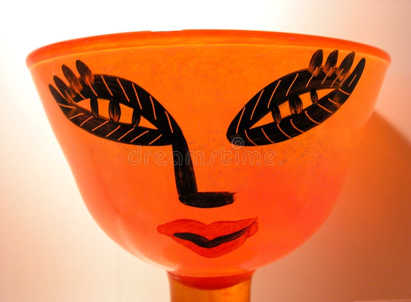 A colourful glass bowl with a human face decoration royalty free stock image