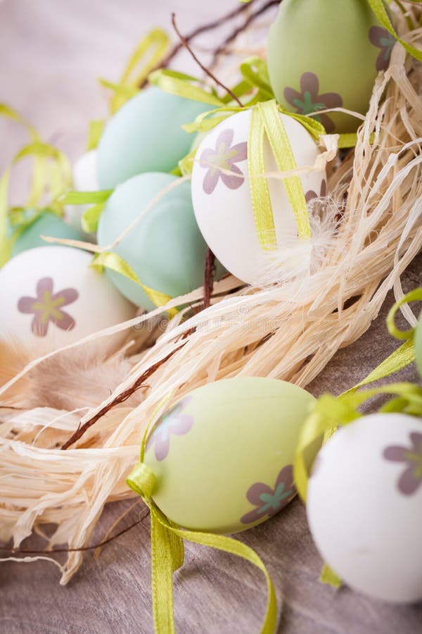 Colourful green Easter eggs in straw