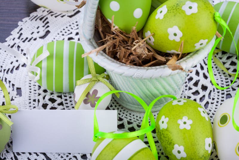 Colourful green Easter eggs in straw