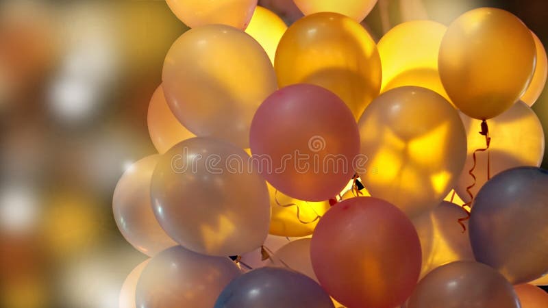 Colourful illuminated party balloons at night with back light