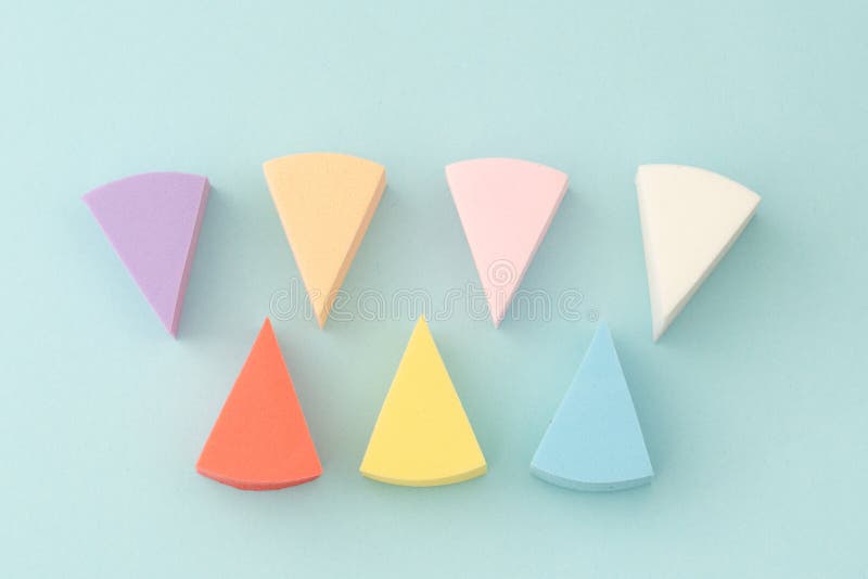 Colourful Makeup Sponges Triangular Shape on a Blue Background Stock