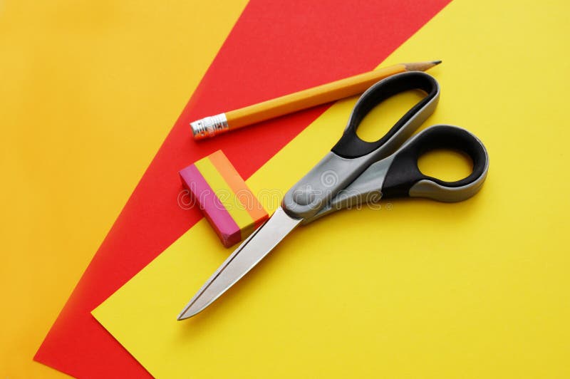 Colourful papers, scissors, pencil and eraser