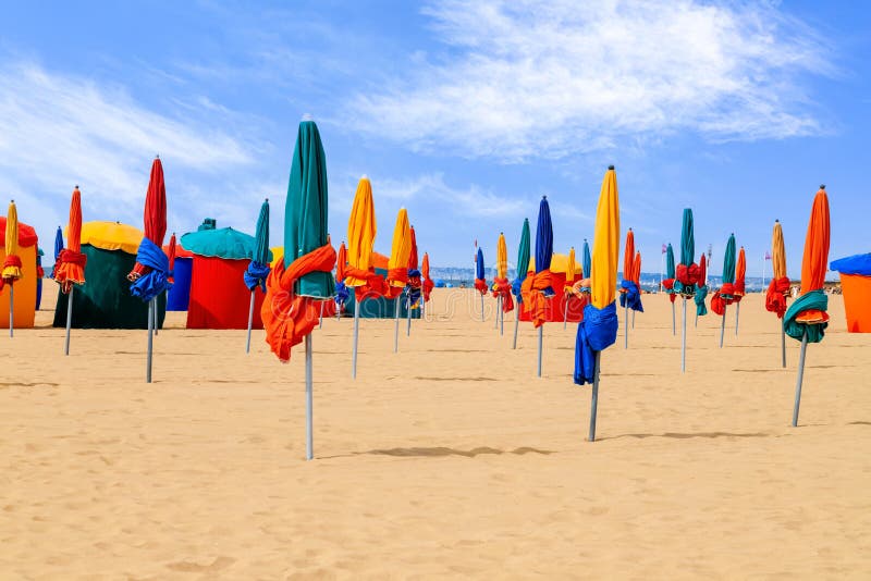 Colourful parasols, landmark of Deauville Beach, resort in Normandy, Northern France. Summer holidays. royalty free stock photography