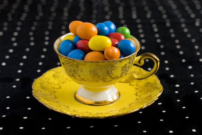 Colourful sweets in vintage teacup