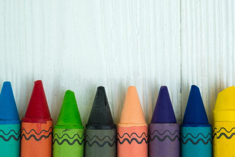 Colourful Wax Crayons Pencils on White Wood Table with Copy Space