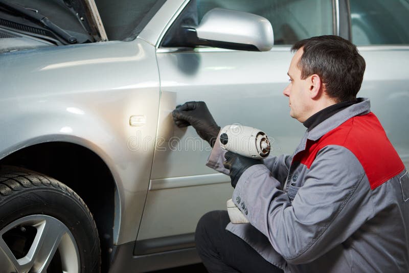 Colourist man compare color sample with car paint royalty free stock photos Colourist man compare color sample with car paint royalty free stock photos