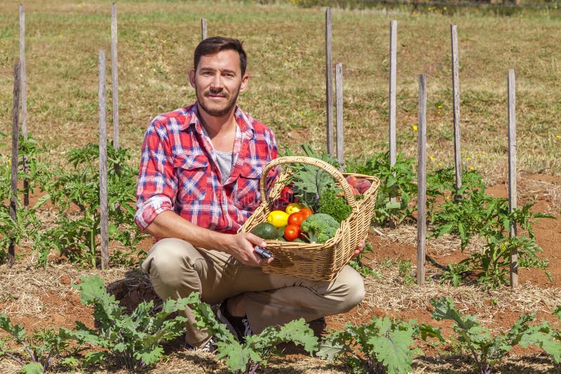 Organic farmer with fresh fruit and vegetables in garden. Organic farmer with fresh fruit and vegetables in garden