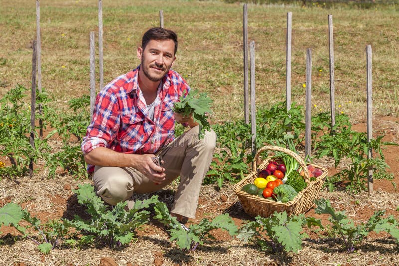 Organic farmer with fresh fruit and vegetables in garden. Organic farmer with fresh fruit and vegetables in garden