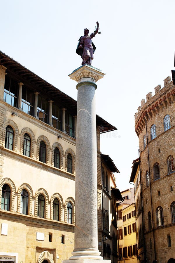 Florence, Italy, June 3, 2019: Column of Justice is an ancient Roman marble Doric column re-erected by the Medici dynasty in the Renaissance as a free standing victory monument with a porphyry statue of Justice at the top. It stands in the Piazza Santa Trinita, Florence. Florence, Italy, June 3, 2019: Column of Justice is an ancient Roman marble Doric column re-erected by the Medici dynasty in the Renaissance as a free standing victory monument with a porphyry statue of Justice at the top. It stands in the Piazza Santa Trinita, Florence