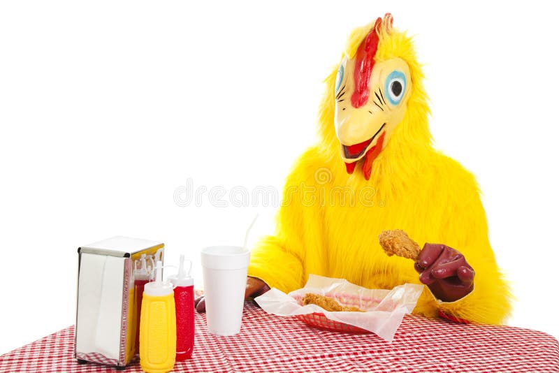 Man in a chicken suit sitting down to eat a fried chicken dinner. Isolated on white. Man in a chicken suit sitting down to eat a fried chicken dinner. Isolated on white.