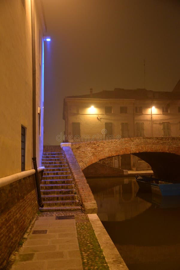 Comacchio, Italy. Night view of a canal bridge. winter fog royalty free stock image Comacchio, Italy. Night view of a canal bridge. winter fog royalty free stock image