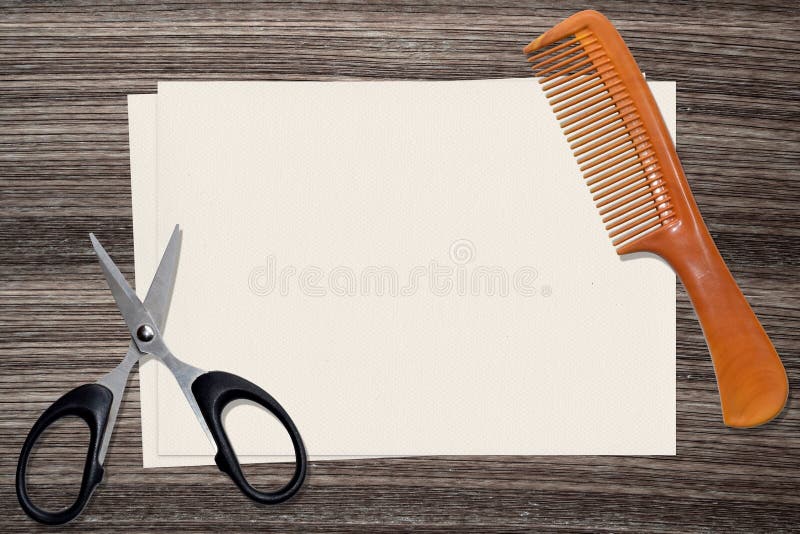 Comb, scissors and paper on wood background royalty free stock photo