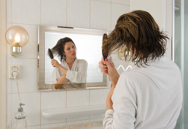Combing hair in bathroom stock photo. Image of care, hairstyle 34244840