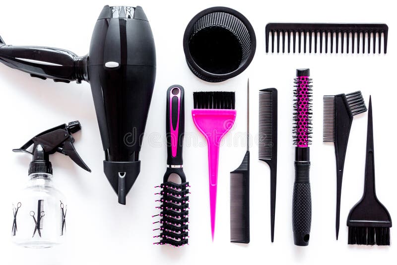 Combs and hairdresser tools in beauty salon on white background top view
