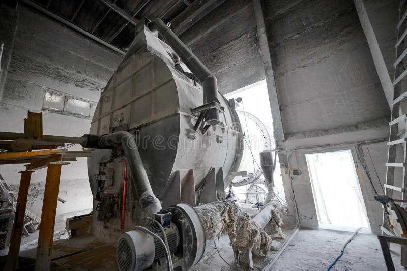 Combustion chamber of tubular rotary kiln at calx factory. Details of manufacturing equipment at large limestone industrial complex upper view