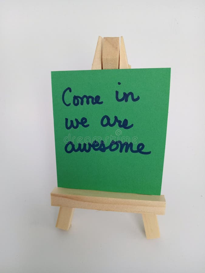 Come in we are Awesome Sign on a Wood Easel on a White Background Stock