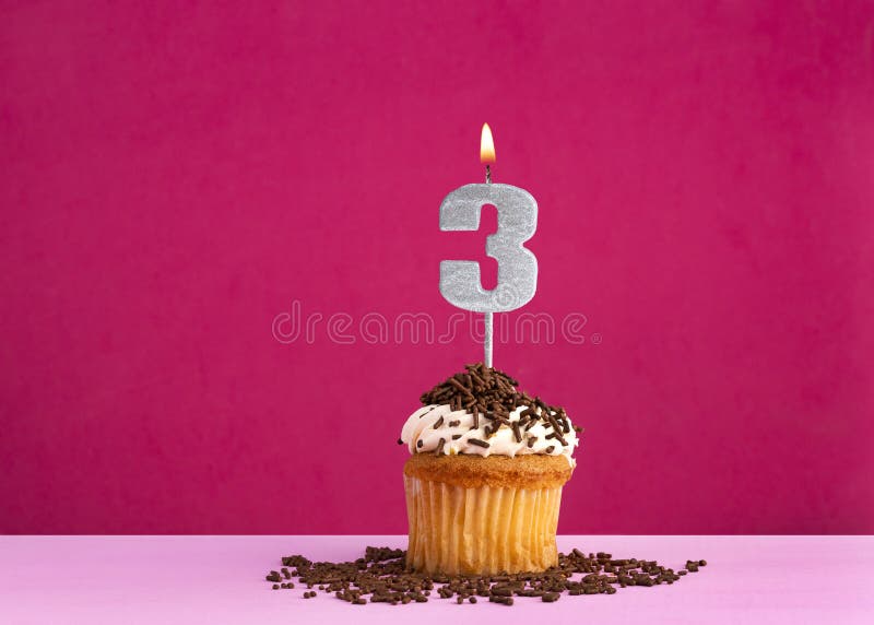 Birthday cupcake with candle number 3 - Birthday card on pink background. Birthday cupcake with candle number 3 - Birthday card on pink background