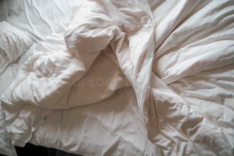 Comfortable bed with white linen Messy. White pillow with blanket on bed unmade. Concept of relaxing after morning stock photo Comfortable bed with white linen Messy. White pillow with blanket on bed unmade. Concept of relaxing after morning stock photo