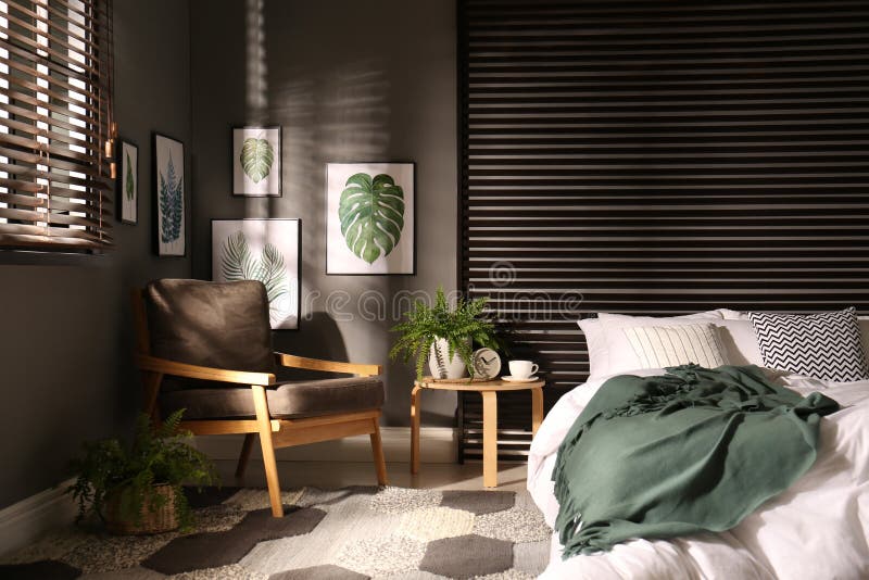 Comfortable Bedroom with Armchair and Pictures on Wall. Interior Design