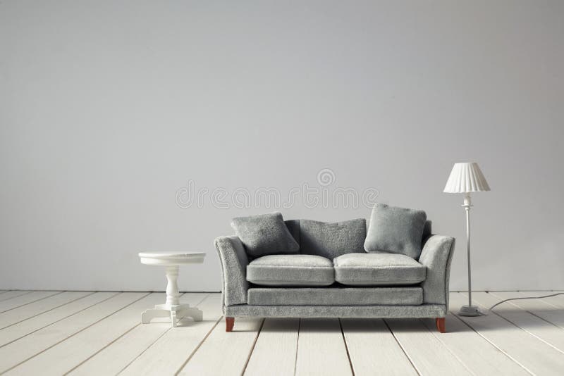 Comfortable Grey Sofa with Table on Light Wall Background Stock Photo -  Image of lounge, clean: 161367566