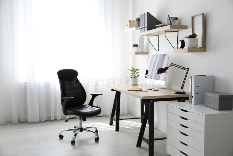 Comfortable Office Chair Near Desk with Modern Computer Indoors Stock