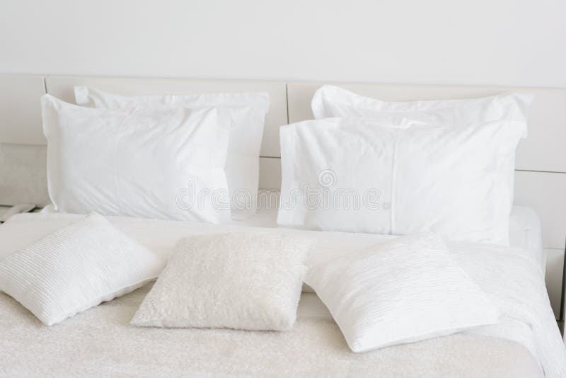 Comfortable Soft Pillows on the Bed. Closeup White Bedding Sheets and
