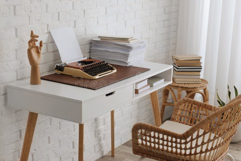 Comfortable Writer`s Workplace with Typewriter on Desk Near White Brick