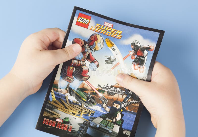 Comic book Lego Super Heroes in child's hands royalty free stock photos Comic book Lego Super Heroes in child's hands royalty free stock photos
