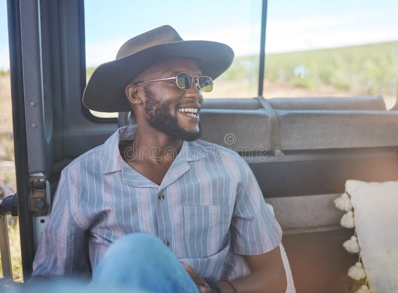 Comic, happy and black man on a road trip in van during holiday on the countryside of California. Thinking, relax and stock photo