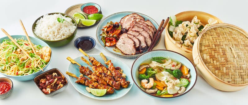 High Angle Panoramic Still Life View of Assortment of Chinese Asian Inspired Food Dishes in front of White Background. High Angle Panoramic Still Life View of Assortment of Chinese Asian Inspired Food Dishes in front of White Background