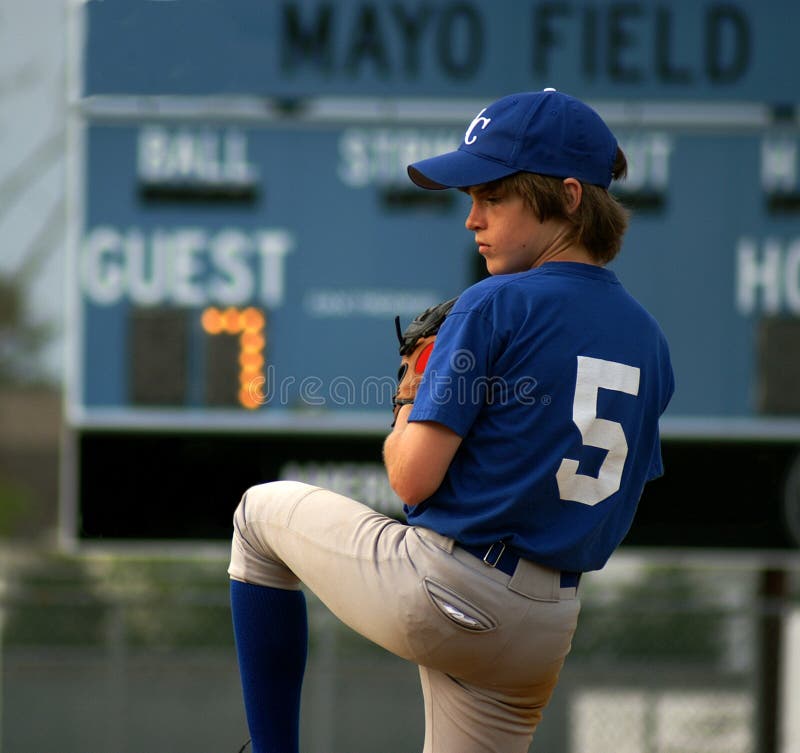 Little league pitcher winding up for the pitch. Little league pitcher winding up for the pitch