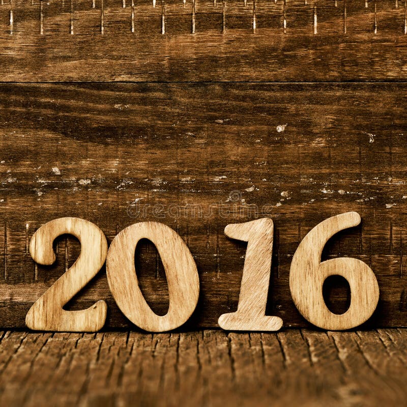 Wooden numbers forming the number 2016, as the new year, on a rustic wooden surface. Wooden numbers forming the number 2016, as the new year, on a rustic wooden surface