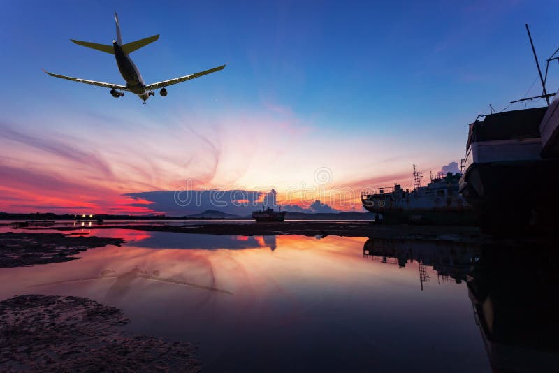 Commercial airplane flying above clouds with dramatic sunset or stock photos Commercial airplane flying above clouds with dramatic sunset or stock photos
