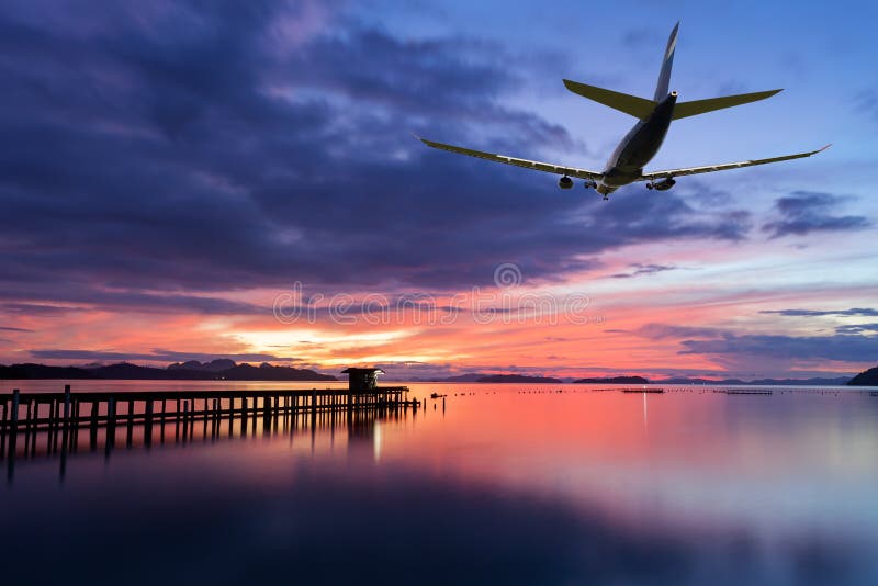 Commercial airplane flying above clouds with dramatic sunset or stock photos Commercial airplane flying above clouds with dramatic sunset or stock photos