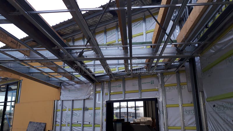 Modern Australian Commercial building construction under Building code of Australia National Construction Code detailing fire safety measures, structural steel beams and posts, flashing wiring, plumbing, warning systems, insulation, and partition walls. Load structural stock images, royalty-free photos and pictures