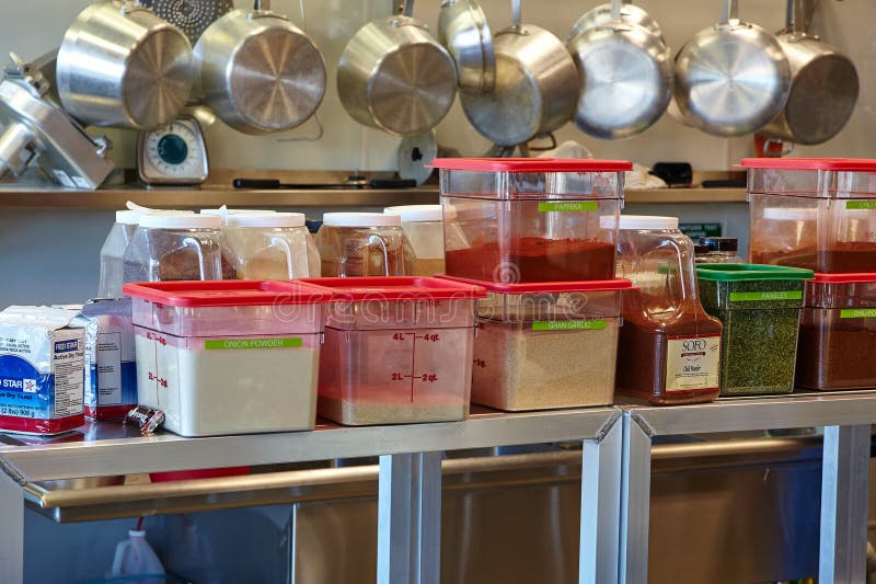 Commercial Kitchen Ingredient Storage and Cookware Setup Stock Photo