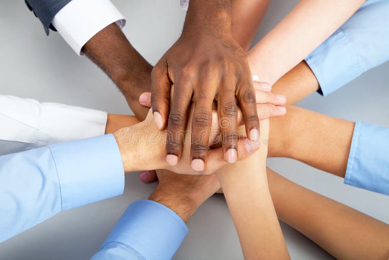 Closeup of business team putting their hands on top of each other. Closeup of business team putting their hands on top of each other