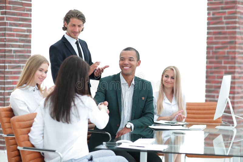 Business team applauding business partners after signing the contract.the concept of cooperation. Business team applauding business partners after signing the contract.the concept of cooperation