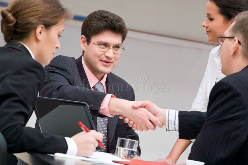 Image of businessmen shaking hands at meeting. Image of businessmen shaking hands at meeting