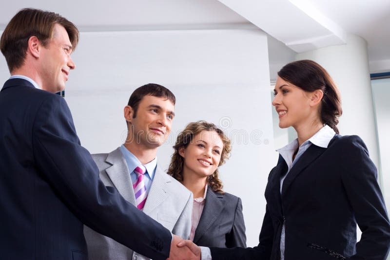 Image of businessman and woman shaking hands at meeting. Image of businessman and woman shaking hands at meeting