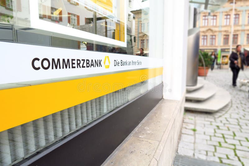 Abstract angle on a window of the German Commerzbank bank with their slogan, people and copy space to the right. Abstract angle on a window of the German Commerzbank bank with their slogan, people and copy space to the right