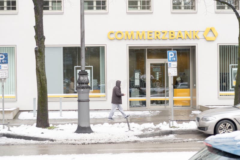 Commerzbank bank with a person walking by and lots of copy space