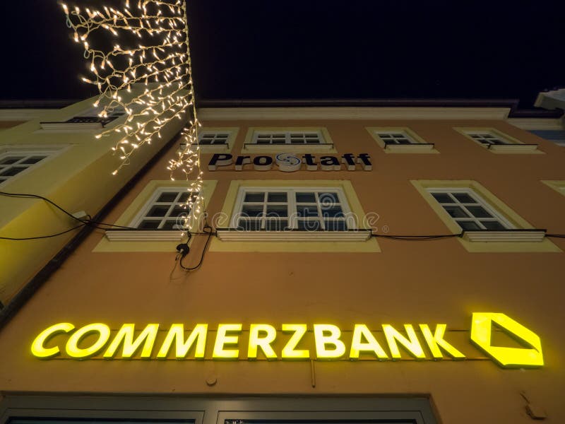 Sign on a Commerzbank bank during night time - copy space above. Sign on a Commerzbank bank during night time - copy space above