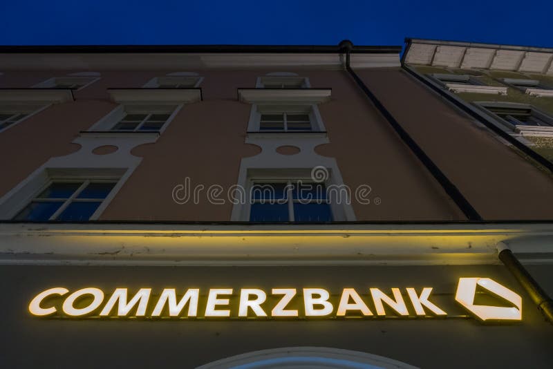 Sign on a german Commerzbank during night time with copy space above it. Sign on a german Commerzbank during night time with copy space above it